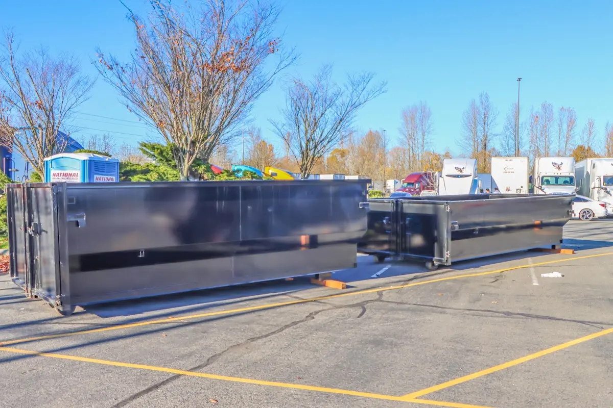 Professional dumpster rental service with roll-off container on residential driveway in North Bend